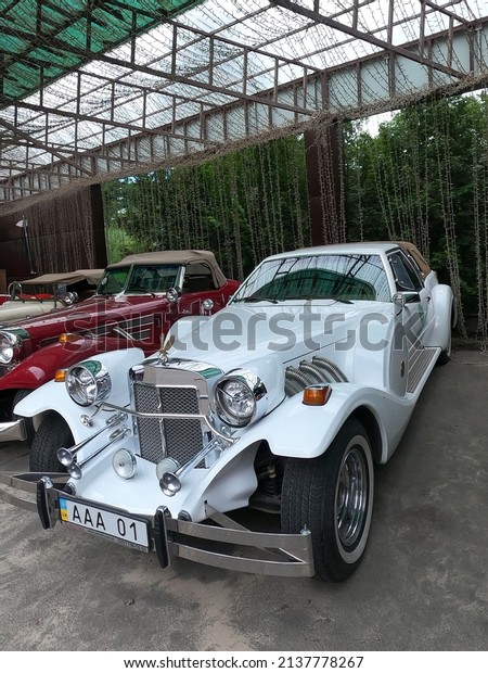 Mercedes - Gazelle from 1929 retro car and Lotus\
seven. Collection cars on display in the park. Vintage white\
mercedes convertible and Lotus Seven. Eco Park Feldman. Kharkov,\
Ukraine, July 3, 2021