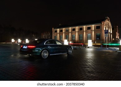 A Mercedes S-Class parked at night in front of one of the buildings of the Silesian Museum. Katowice, Poland - 02.02.2021