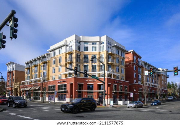 MERCER ISLAND, WA, USA – JANUARY 22, 2022:\
Downtown Mercer Island, street intersection with modern mixed-use\
buildings on opposite\
street\
