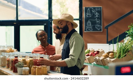 Merchant offering bio food alternative with variety of pasta as bulk products, recommending healthy groceries to diverse couple. Friendly vendor sharing pasta bolognese recipe with clients. - Powered by Shutterstock