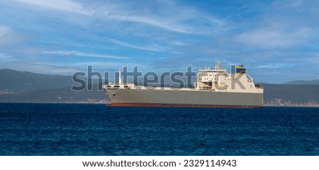 A merchant ship waiting to enter port to load armaments
