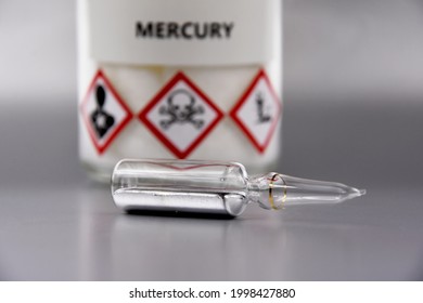 Mercury chemical element stock images. Laboratory accessories images. Mercury in a sealed ampoule stock photo. Laboratory equipment on a silver background. Hg, toxic chemical element stock images