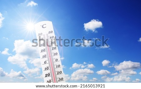 Mercury thermometer. Summer heat or global warming climate change concept.
