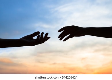 mercy, two hands silhouette on sky background, connection or help concept - Shutterstock ID 544206424