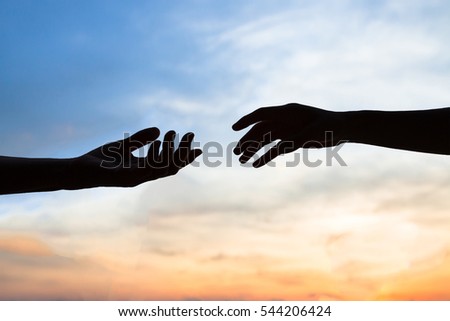 mercy, two hands silhouette on sky background, connection or help concept