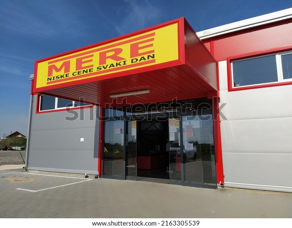 MERE discounter chain stores, Ruma, Serbia, April\
15, 2022. Inscription - Low prices every day. Facade and entrance\
to the supermarket with logo and brand. Food and household goods at\
cheap prices