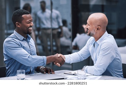 Merge with people who match your ambition. two businessmen shaking hands during a meeting. - Shutterstock ID 2281800251