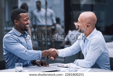 Merge with people who match your ambition. two businessmen shaking hands during a meeting.