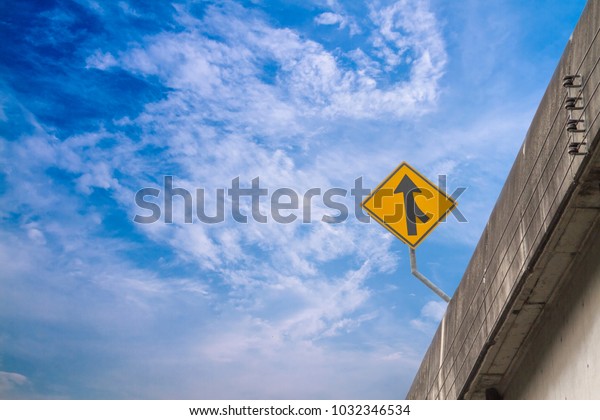Merge road sign on the high express way and\
sky background.
