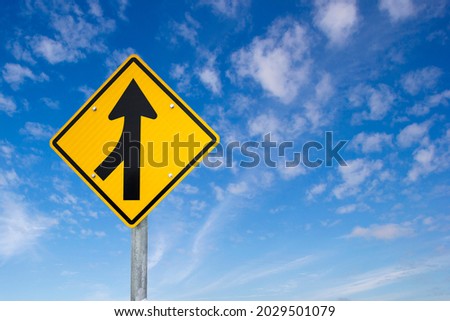 Merge road sign as symbol of cooperation. Merging Sign, Road, Diamond Shaped, Directional Sign. Business decisions concept with traffic sign