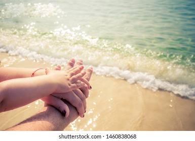 The merged hands of mother, father and child on the beach at the sea. Family hands piece together on the beach. - Shutterstock ID 1460838068