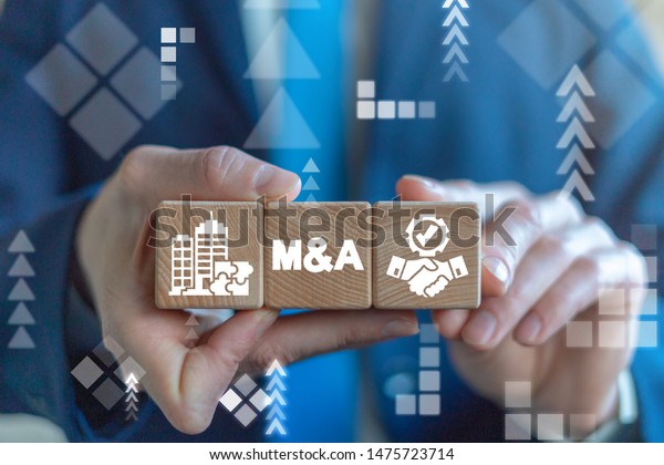 Merger and Acquisition Business Corporate\
Cooperation Company concept. MA partnership concept on wooden dices\
in businessman\'s hands.