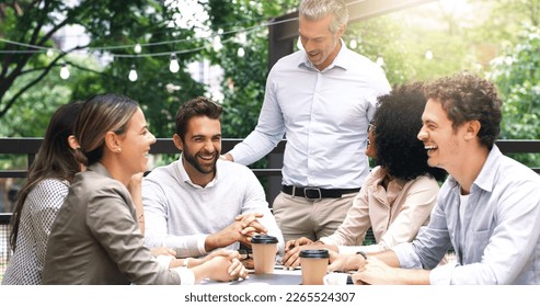 Merging their ideas around the table. Shot of a group of colleagues having a meeting at a cafe. - Powered by Shutterstock