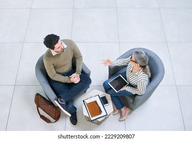 Merging their skills and ideas to do great business together. High angle shot of two businesspeople having a discussion in an office.