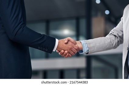 The merging of two business greats. Cropped shot of two businessmen shaking hands in a modern office. - Shutterstock ID 2167544383