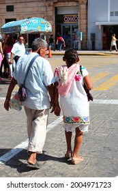 Merida, Mexico - 07.21.2013: Old Mexican Couple In Traditional Embroidered Outfit On The Main Square Plaza Grande Of Colonial City Of Merida, Yucatan Peninsula, Mexico