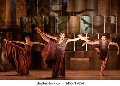 Merida, Spain - July 18, 2019: 65th Edition Of The International Festival Of Classical Theatre In Merida. Play “Antigone” By Ballet Company Of Victor Ullate. Trio Of Dancers In Full Stretch