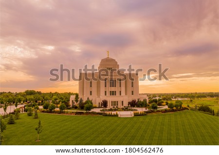 Meridian Idaho Temple lit by a dramatic sunset