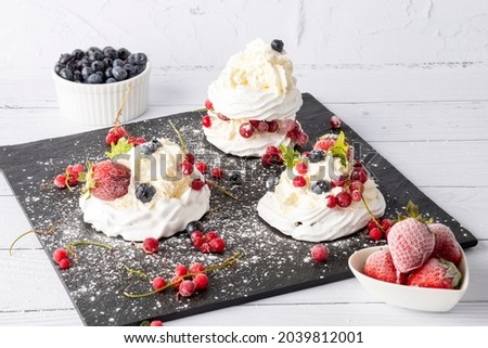 Meringue cake with fresh strawberries and blueberries. Cake Anna Pavlova. Close up.