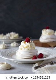 Meringue dessert Pavlova with whipped cream and raspberry