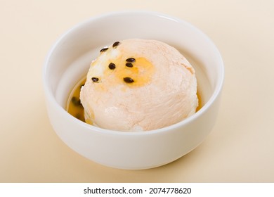 
Meringue With Passion Fruit Curd And Syrup Or Sauce In White Bowl On Beige Background Or Cream Background Or Light Yellow Background. Closeup.