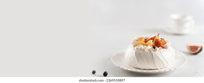 Meringue Pavlova cake banner. Anna Pavlova cake with peach, figs, blueberries and vanilla cream on white background. Web line, copy space. Summer meringue dessert recipe, menu. Confectionery menu
