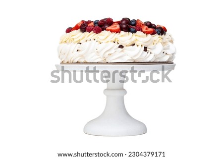 Meringue Pavlova cake with whipped cream and fresh berries isolated, strawberries and blueberries on white background. Horizontal orientation