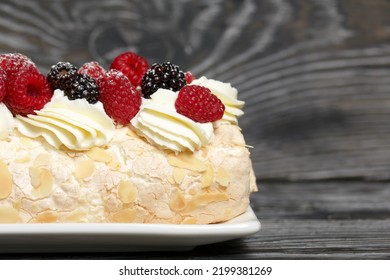 Meringue Roll With Mascarpone Cream. Garnished With Raspberries And Almond Petals. Close-up.