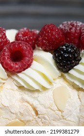 Meringue Roll With Mascarpone Cream. Garnished With Raspberries And Almond Petals. Close-up.