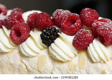 Meringue Roll With Mascarpone Cream. Garnished With Raspberries And Almond Petals. Close-up.