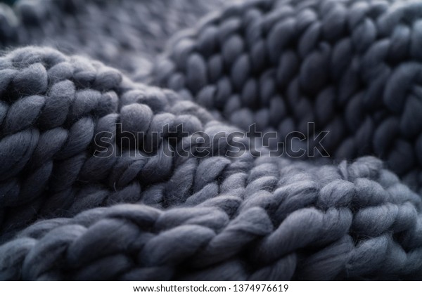 Merino wool\
handmade knitted large blanket, super chunky yarn, trendy concept.\
Close-up of knitted blanket, merino wool background. designer\
blanket made of beige smoky\
wool