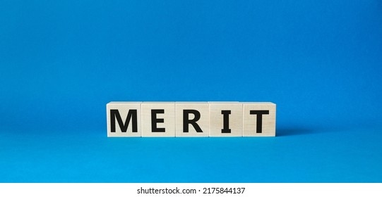 Merit Symbol. Concept Word Merit On Wooden Cubes. Beautiful Blue Background. Business And Merit Concept. Copy Space.