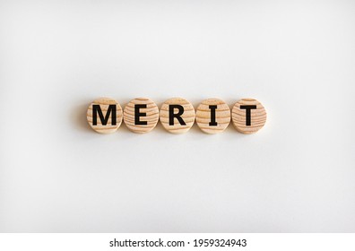 Merit Symbol. Wooden Circles With The Word 'merit'. Beautiful White Background, Copy Space. Business And Merit Concept.