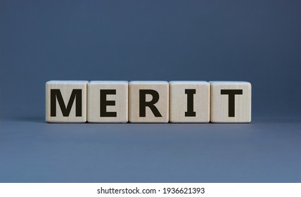 Merit Symbol. Wooden Cubes With The Word 'merit'. Beautiful Grey Background, Copy Space. Business And Merit Concept.