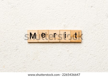 merit word written on wood block. merit text on table, concept.