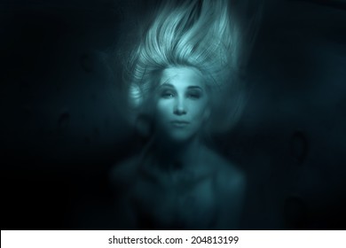 Mermaid.Toned photo of face under water