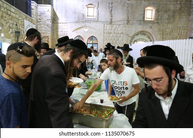 MERON, ISRAEL - AUG 1, 2017: Unidentified Jewish Men Break The Fast Of The Holiday Of Tisha Bav On A Meal In Meron, Israel