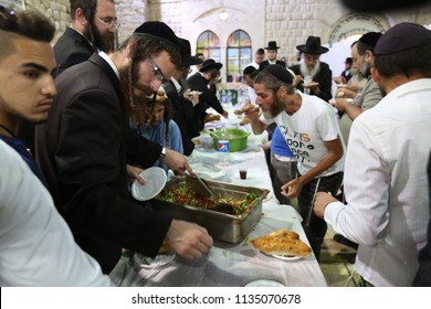 MERON, ISRAEL - AUG 1, 2017: Unidentified Jewish Men Break The Fast Of The Holiday Of Tisha Bav On A Meal In Meron, Israel