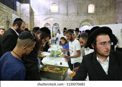 MERON, ISRAEL - AUG 1, 2017: Unidentified Jewish Men Break The Fast Of The Holiday Of Tisha Bav On A Meal In Meron, Israel