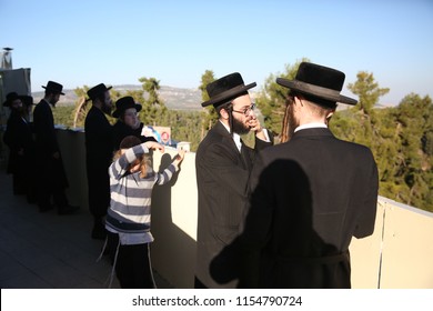 MERON, ISRAEL - JULY 1, 2018: Two Unidentified Hasidic Jewish Men Standing And Talking Outside The Grave Of Rabbi Shimon Bar Yochai In Meron, Israel