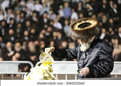 MERON, ISRAEL - MAY 14, 2017:  Rabbi Of Rachmastrivka Pours Oil On Bonfire On The Holiday Of Lag Baomer At The Grave Of Rabbi Shimon Bar Yochai In Meron, Israel