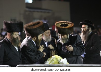 MERON, ISRAEL - MAY 14, 2017:  Rabbi Of Rachmastrivka Pours Oil On Bonfire On The Holiday Of Lag Baomer At The Grave Of Rabbi Shimon Bar Yochai In Meron, Israel