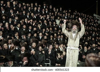 Meron,Israel,February 25 2017-Rabbi Elimelech Biderman,Rabbi to his Jewish flock of religious Hasidim,during the grand "tisch" with his followers. "tisch" is a  tradition between Rebbe and his Hasidim