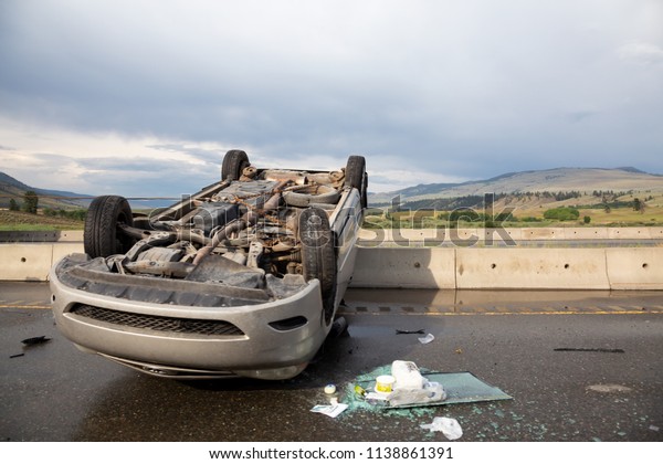 Merritt, BC, Canada - June 21,\
2018: Car flipped upside down after the accident on the\
highway.