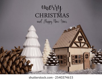 Merry Christmas background featuring a wood house, pine cones, and a white fir tree statue. Perfect for holiday-themed designs and festive decor - Powered by Shutterstock