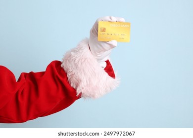 Merry Christmas, Cheerful senior man celebrate winter holidays is holding credit card, wearing Santa Claus costume isolated on yellow and blue background. Merry Xmas - Powered by Shutterstock