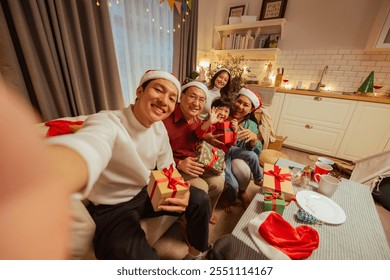 merry christmas, family, selfie, celebrate, gifts, present, celebration, parents, gift, childhood. A family is sitting and posing for a picture with Christmas presents. Scene is festive and joyful. - Powered by Shutterstock