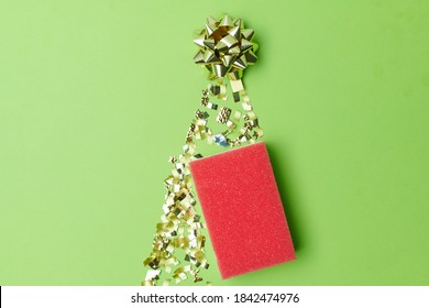 Merry Christmas. Flat Lay With Cleaning Sponge On Green Background.