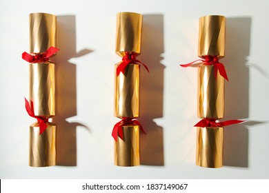 Merry Christmas. Flat Lay With Golden Victorian Christmas Crackers On White Background.