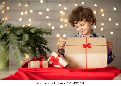 Merry Christmas. Happy Boy Opens A Gift